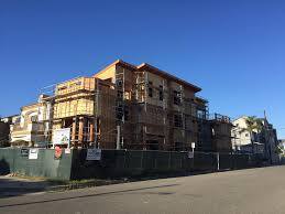 3-story house with roof deck, during framing