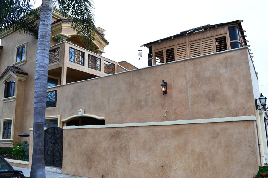 Existing three-story house, roof deck and courtyard wall